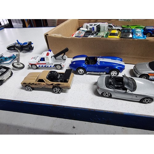 173 - A box containing a large quantity of vintage diecast cars including an early vintage police car whic... 