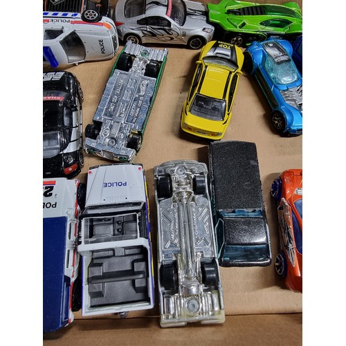 173 - A box containing a large quantity of vintage diecast cars including an early vintage police car whic... 