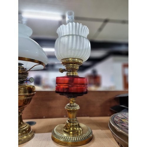 283 - Quantity of 3x brass oil lamps inc a good quality oil lamp with a ruby glass reservoir, 2x are compl... 