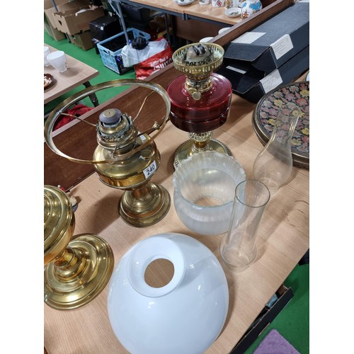 283 - Quantity of 3x brass oil lamps inc a good quality oil lamp with a ruby glass reservoir, 2x are compl... 