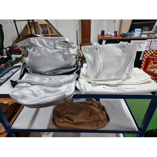 187 - 3 x ladies handbags including a good quality Balenciaga white leather handbag with its dust cover al... 