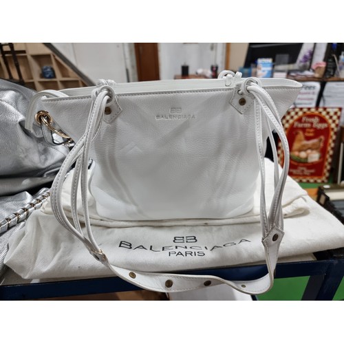 187 - 3 x ladies handbags including a good quality Balenciaga white leather handbag with its dust cover al... 