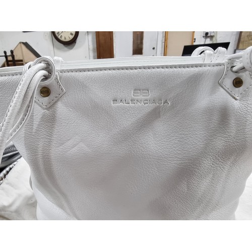 187 - 3 x ladies handbags including a good quality Balenciaga white leather handbag with its dust cover al... 