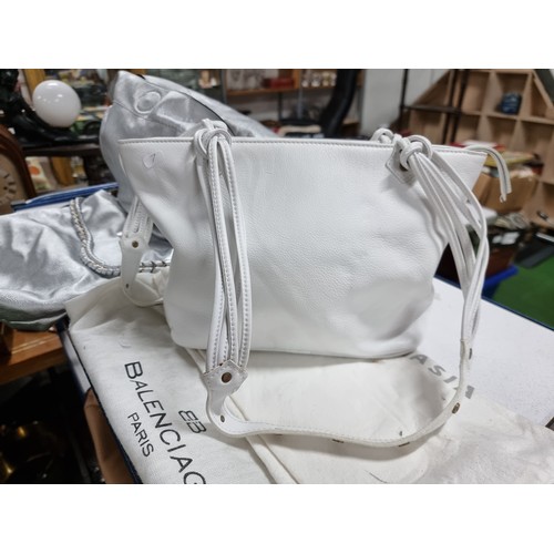 187 - 3 x ladies handbags including a good quality Balenciaga white leather handbag with its dust cover al... 