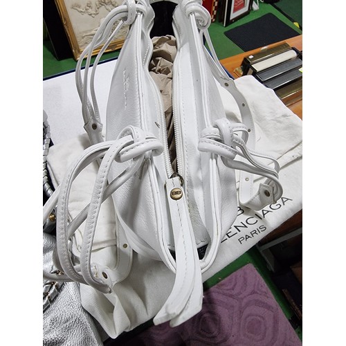 187 - 3 x ladies handbags including a good quality Balenciaga white leather handbag with its dust cover al... 