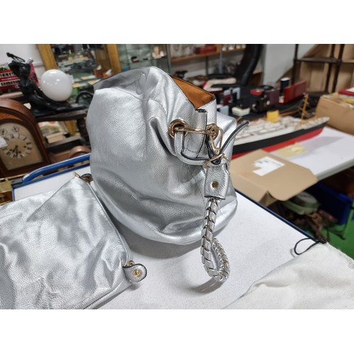 187 - 3 x ladies handbags including a good quality Balenciaga white leather handbag with its dust cover al... 