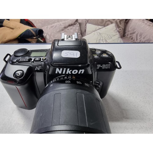 211 - A Nikon F/601 35mm camera with a Tamron 70/300mm tele/macro lens, in working condition but requires ... 