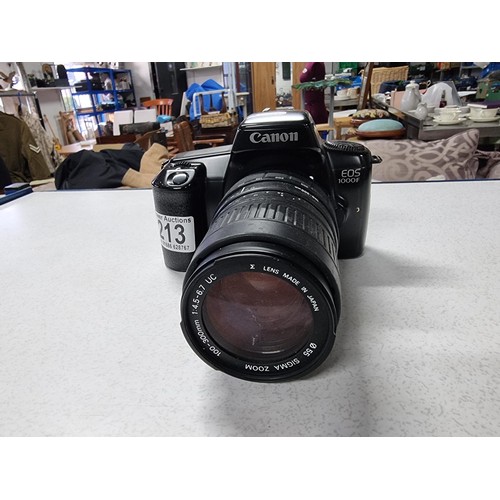 213 - A Canon EOS 1000F 35mm camera with a Sigma zoom 100/300mm lens , in good working condition.