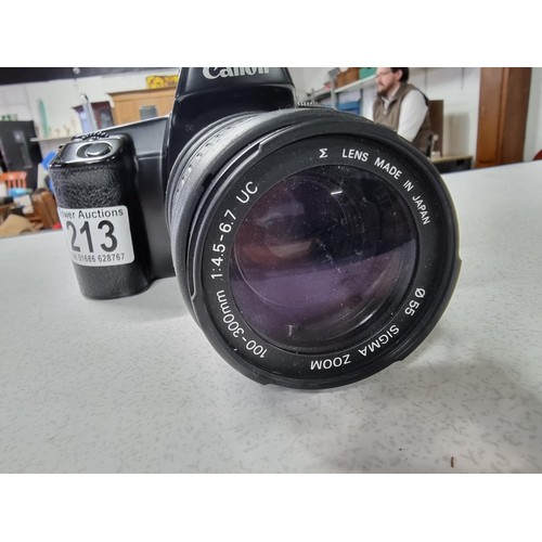 213 - A Canon EOS 1000F 35mm camera with a Sigma zoom 100/300mm lens , in good working condition.