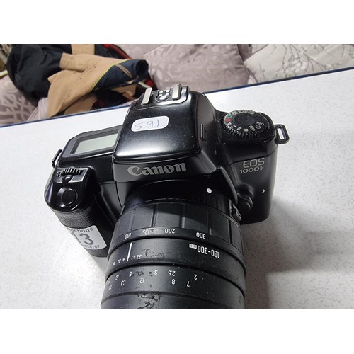 213 - A Canon EOS 1000F 35mm camera with a Sigma zoom 100/300mm lens , in good working condition.