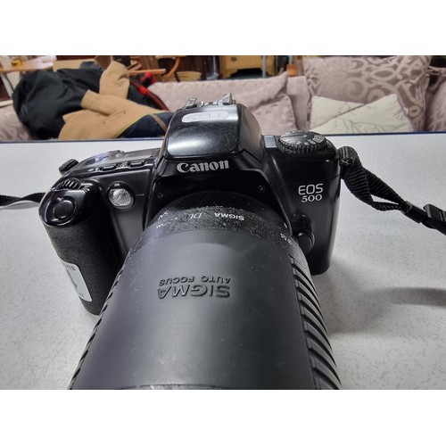 214 - A Canon EOS500 35mm camera with a Sigma auto focus DL zoom 75/300mm lens. In good working condition ... 