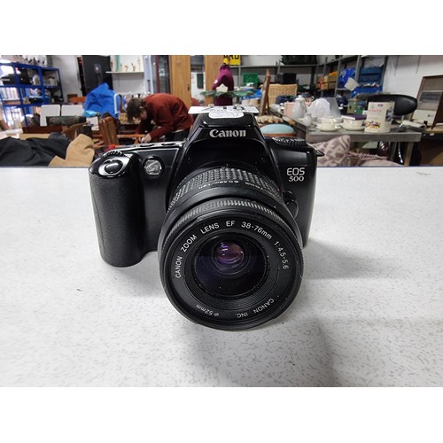 218 - A Canon EOS500 35mm camera with a Canon zoom lens 38/76mm lens. In good working condition just requi... 