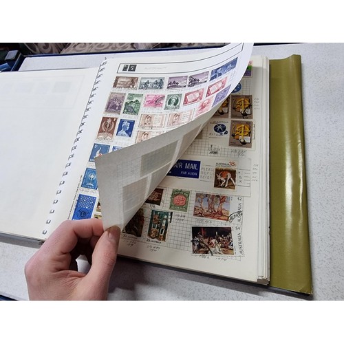 224 - A new world stamp album containing a large quantity of stamps from around the world along with an em... 