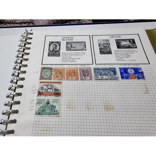 224 - A new world stamp album containing a large quantity of stamps from around the world along with an em... 