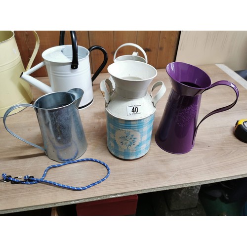 40 - Quantity 3x garden metal watering cans, 2 metal jugs and a ornamental small churn. Height of tallest... 