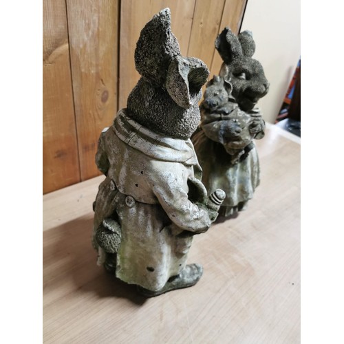 45 - Pair of vintage stoneware garden figures, Mr and Mrs Rabbit holding baby rabbits, in overall good or... 