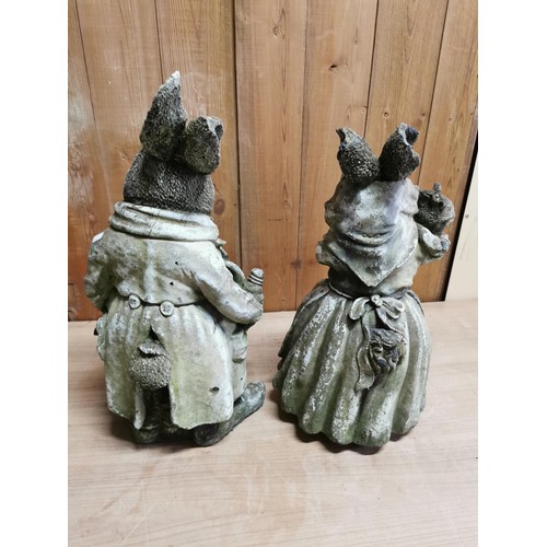 45 - Pair of vintage stoneware garden figures, Mr and Mrs Rabbit holding baby rabbits, in overall good or... 