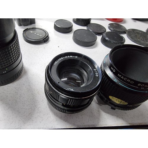 230 - A large collection of 10 x various vintage camera lenses along with some accessories including a Car... 