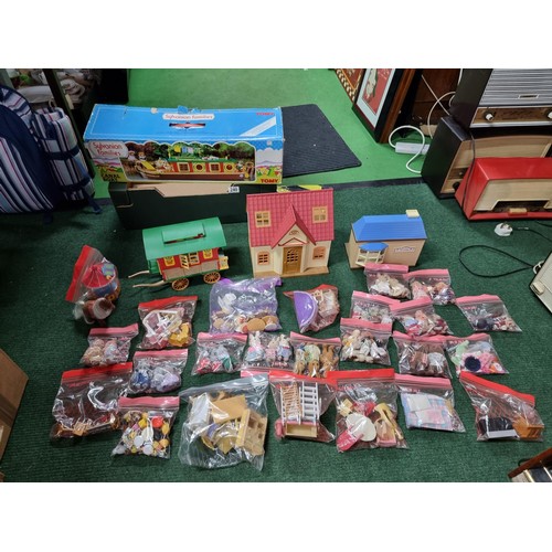 240 - A large collection of Tomy Sylvanian families including a boxed canal boat, 2 houses, gypsy caravan,... 