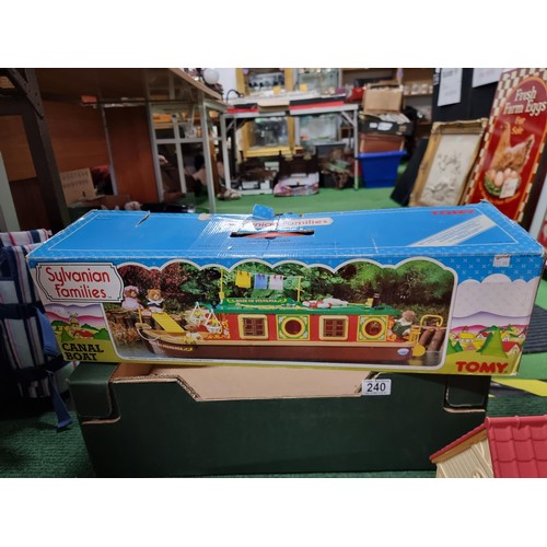 240 - A large collection of Tomy Sylvanian families including a boxed canal boat, 2 houses, gypsy caravan,... 