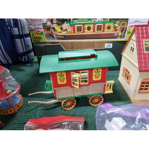 240 - A large collection of Tomy Sylvanian families including a boxed canal boat, 2 houses, gypsy caravan,... 