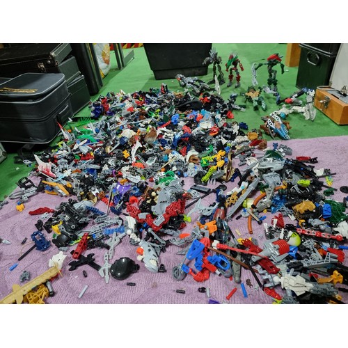 250 - A very large collection of Lego Bionicle figures parts and accessories all stored in a big black box... 