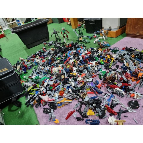 250 - A very large collection of Lego Bionicle figures parts and accessories all stored in a big black box... 