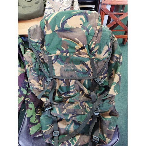 78 - Collection of camouflage clothing inc all weather trousers along with a camouflage rucksack