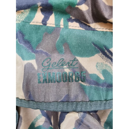 78 - Collection of camouflage clothing inc all weather trousers along with a camouflage rucksack