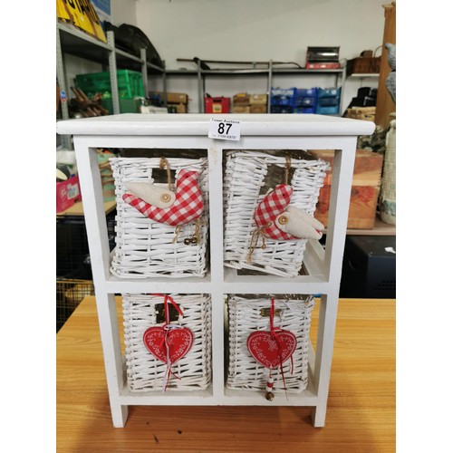 87 - Small wooden 2 shelf storage unit containing 4 wicker baskets each with hand made bird and heart han... 