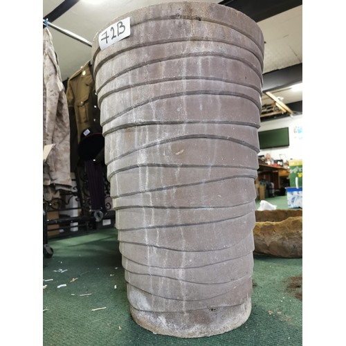 72B - Tall swirl design planter with small chip to the rim in otherwise good overall condition height 62.5... 