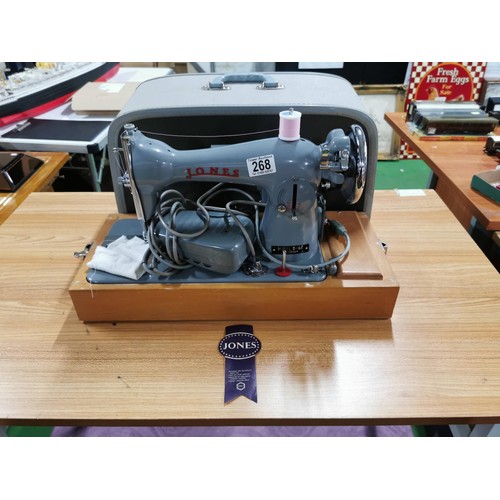 268 - Cased vintage  Jones D-66 foreign sewing machine along with motor light and pedal, inc a quantity of... 