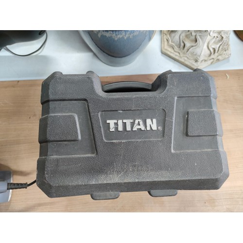 10 - A Titan electric wood planer complete with accessories and hard case, also includes dust bag in full... 