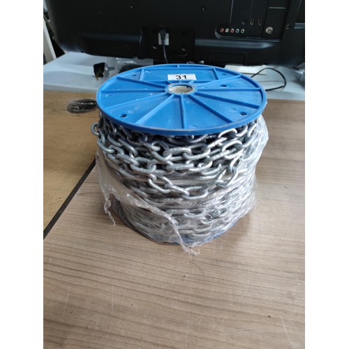 31 - A full new reel of interlocking galvanized chain with 1