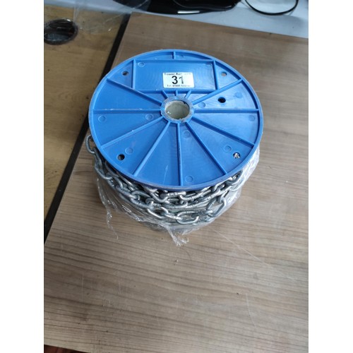 31 - A full new reel of interlocking galvanized chain with 1