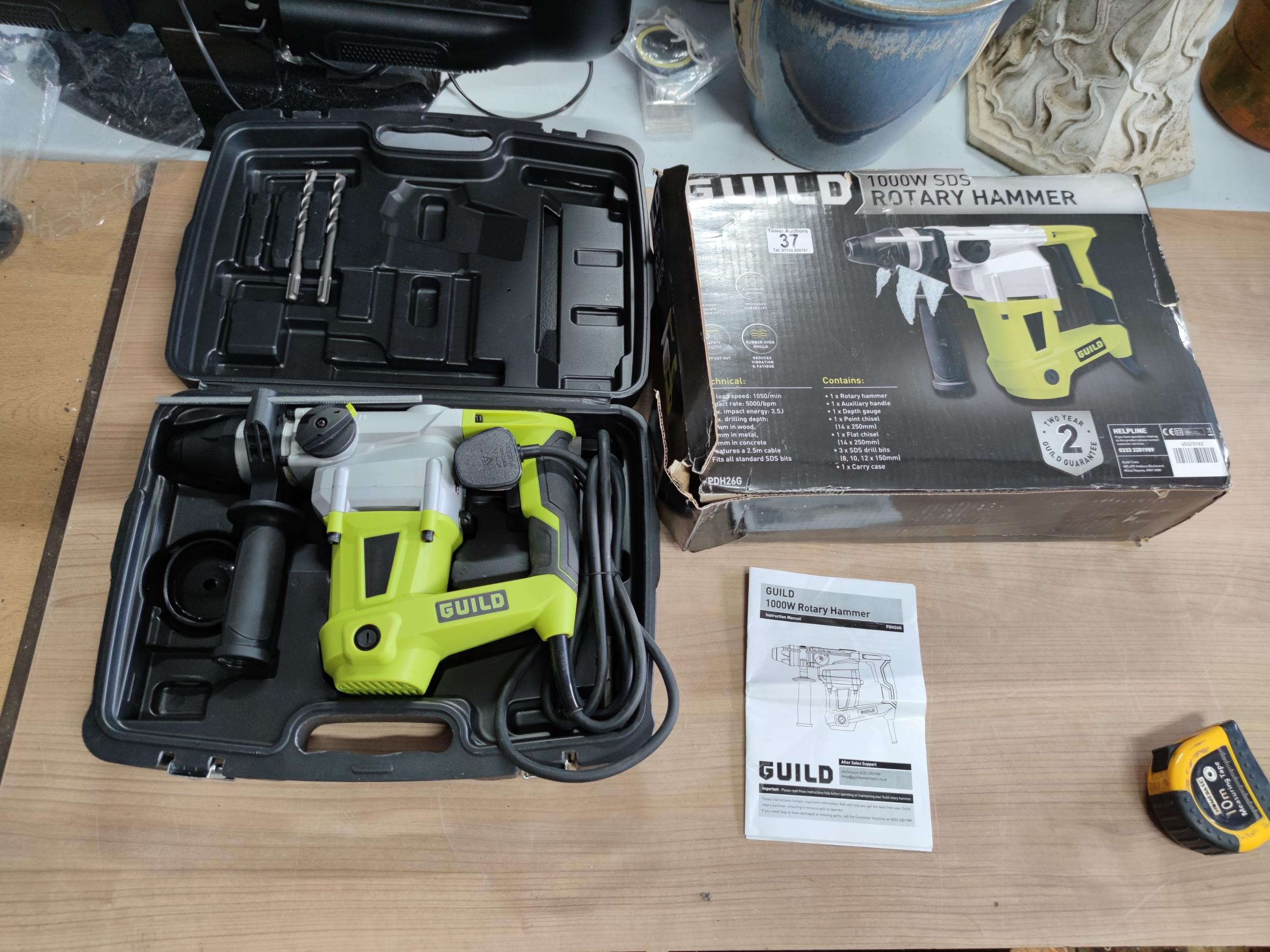 A cased guild 1000w sds rotary hammer drill. Comes with 3 drill