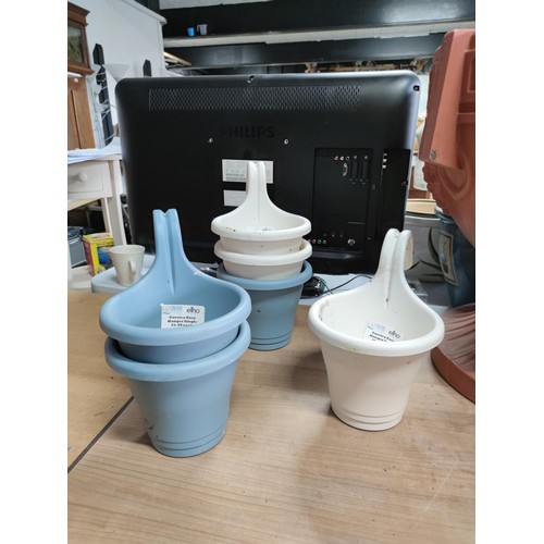 57 - A large quantity of plastic planter including a large urn shaped planter on a pedestal, along with 6... 