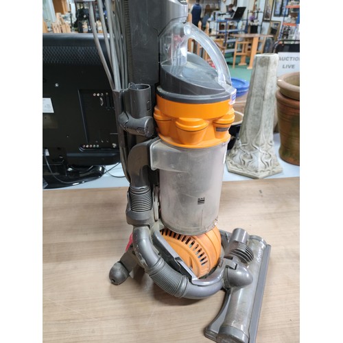 64 - A Dyson DC25 upright ball vacuum cleaner in working condition.