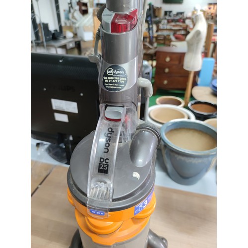 64 - A Dyson DC25 upright ball vacuum cleaner in working condition.