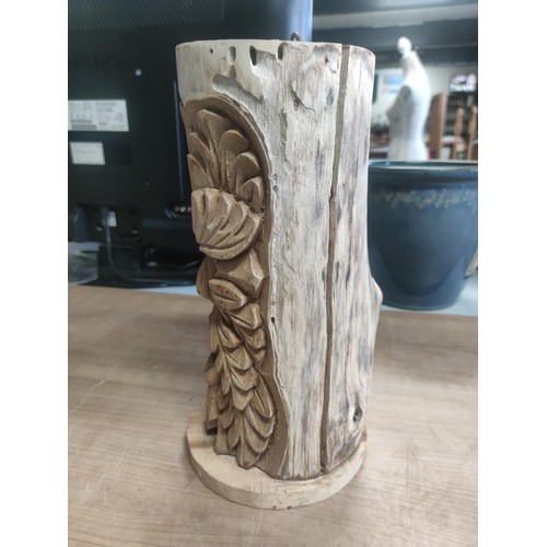 82 - A solid wood bird box with a detailed carving of the green man. In good order.
Height 34cm, diameter... 