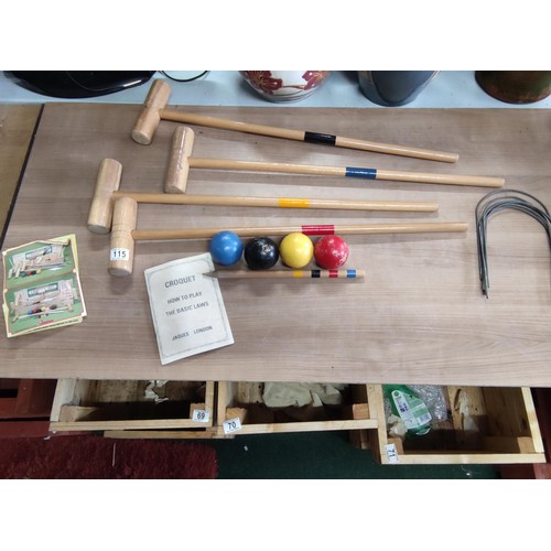 115 - A croquet set by Jaques including 4 hammers, 4 balls, touch peg and hoops, includes instructions.