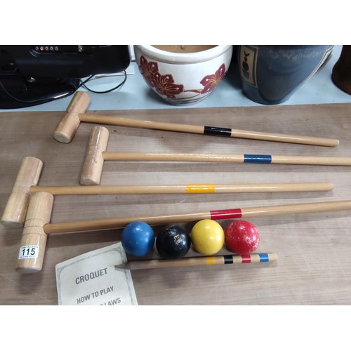 115 - A croquet set by Jaques including 4 hammers, 4 balls, touch peg and hoops, includes instructions.