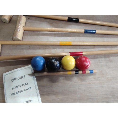 115 - A croquet set by Jaques including 4 hammers, 4 balls, touch peg and hoops, includes instructions.