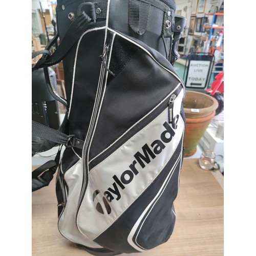 120 - A tailor made lightweight golf bag complete with harness and free standing legs in good order, hardl... 