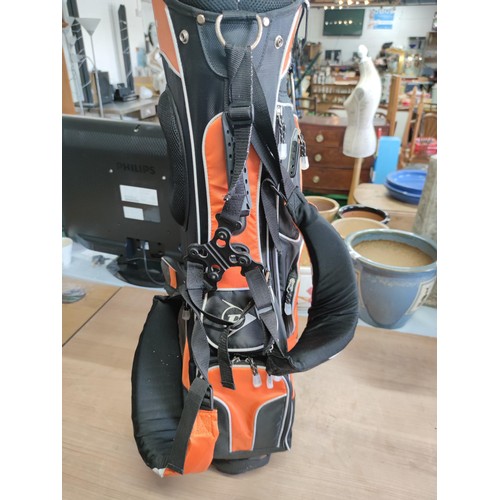 125 - A Dunlop free standing lightweight golf bag in excellent condition with harness and stand, divisiona... 