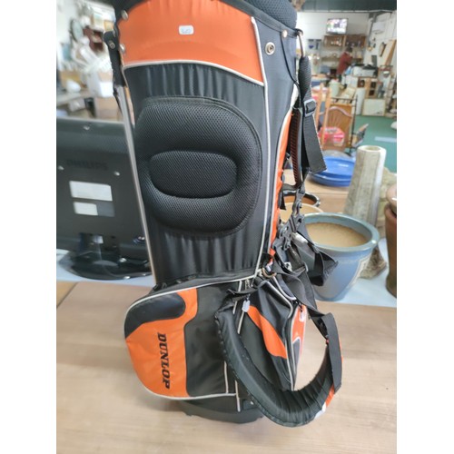 125 - A Dunlop free standing lightweight golf bag in excellent condition with harness and stand, divisiona... 