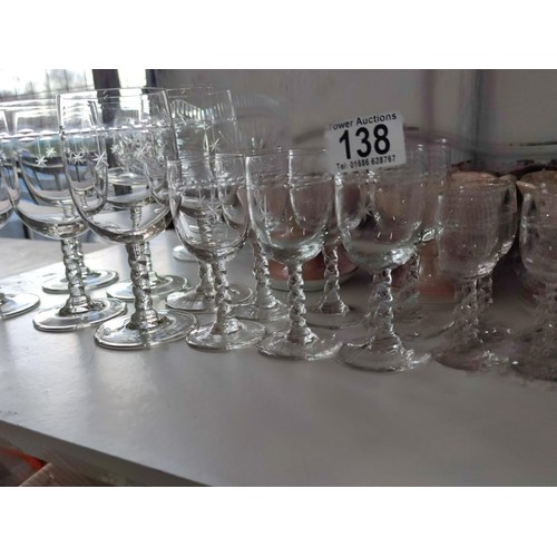 138 - A collection of glassware including wine, sherry and port glasses all with etched star design along ... 