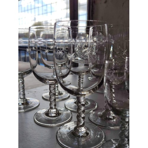 138 - A collection of glassware including wine, sherry and port glasses all with etched star design along ... 