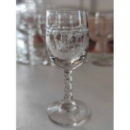 138 - A collection of glassware including wine, sherry and port glasses all with etched star design along ... 