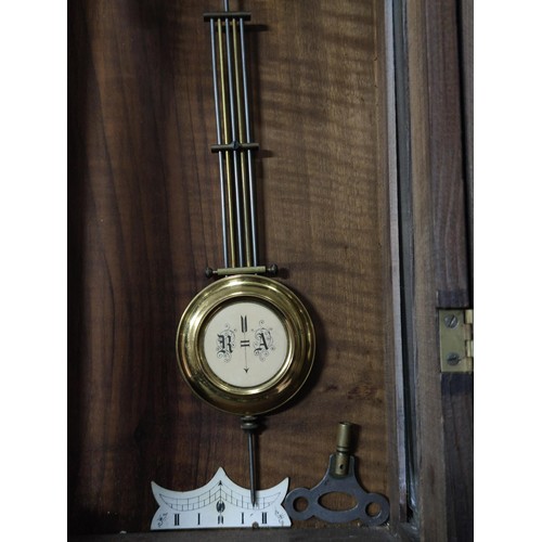 170 - A Vienna wall clock complete with pendulum key in working order, detailing to the top and base requi... 